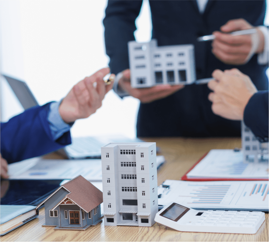 Real estate professionals discussing building models.