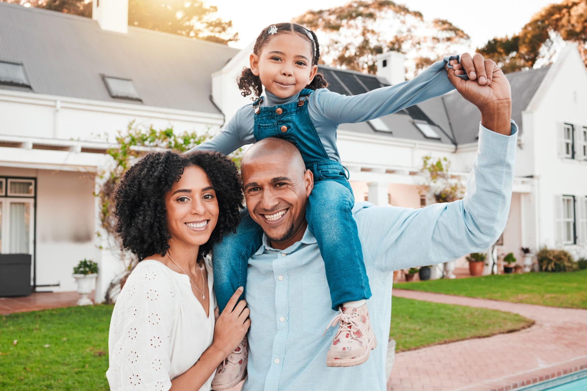Happy family in front of their house.