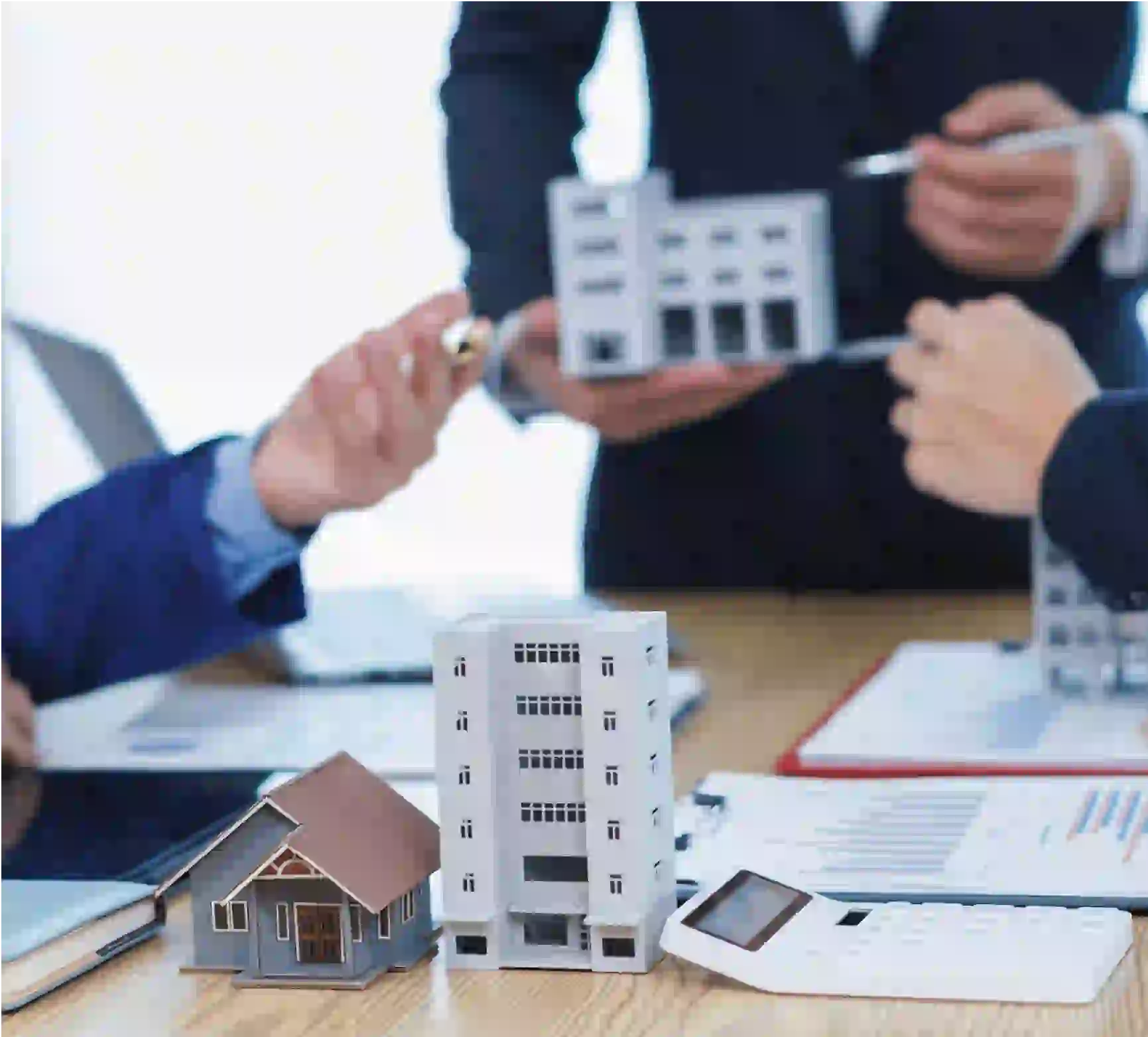 Real estate meeting with building models.